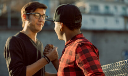 Two men supporting each other